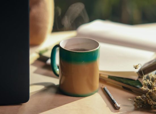 Minimalist tech workspace with a cup of herbal tea